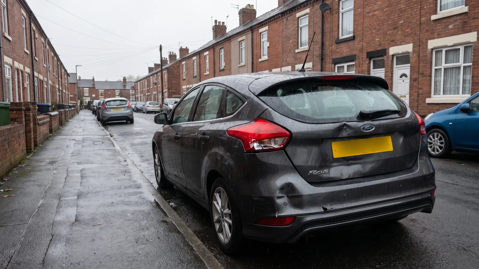 A car with rear-end collision damage parked on a British street