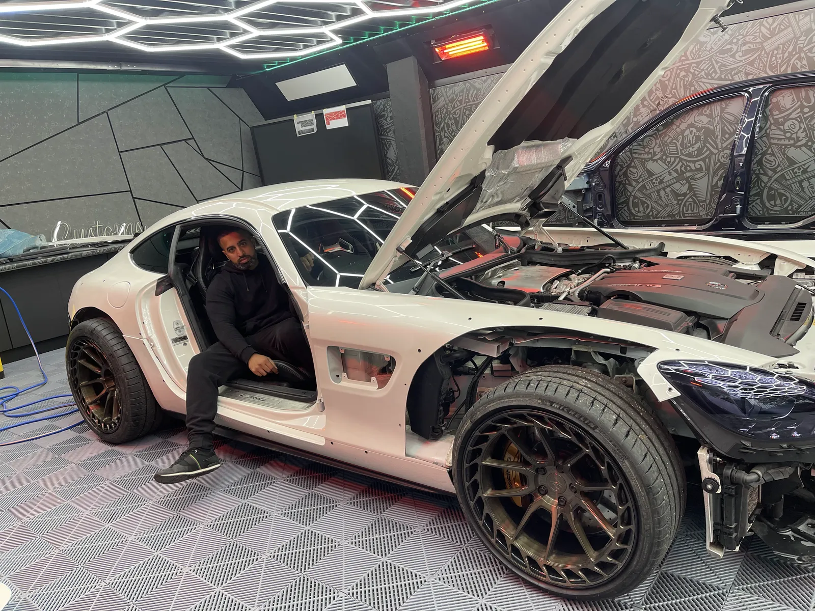 The AMG GT stripped with doors removed and the engine bay open