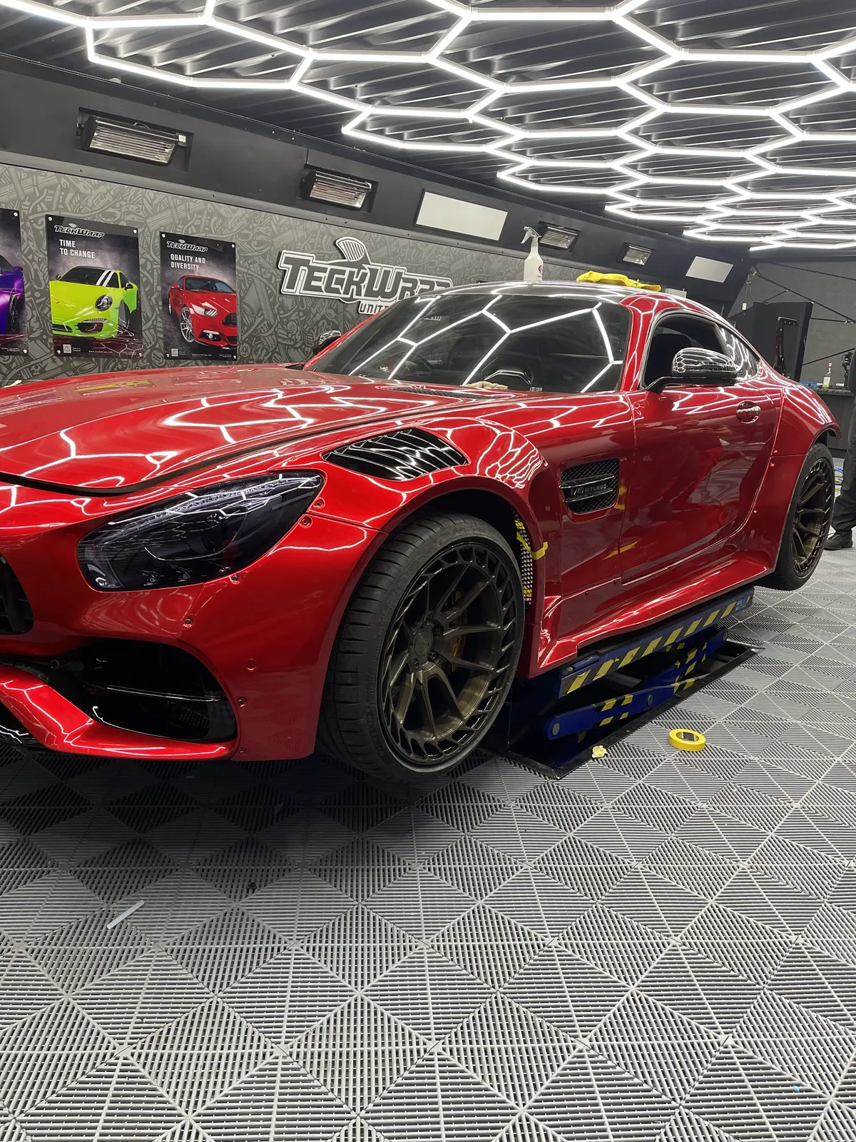 The AMG GT finished in deep gloss red TeckWrap vinyl inside the MSL Customs workshop