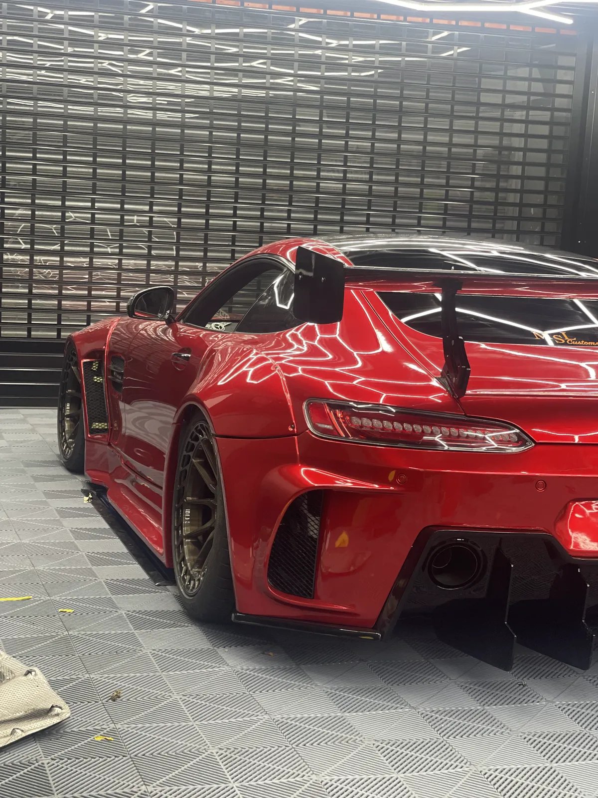Rear three-quarter of the finished red widebody AMG GT with GT wing