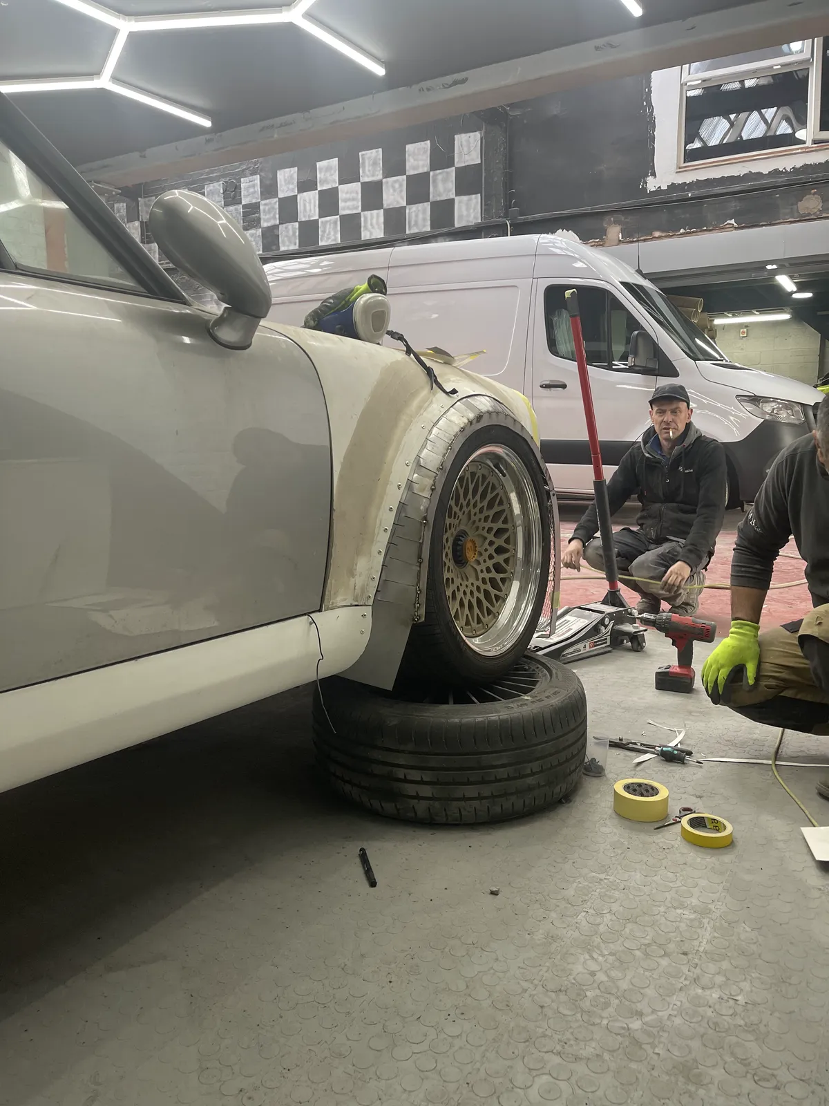 The MSL Customs team working on the Porsche 911's suspension and wheel fitment