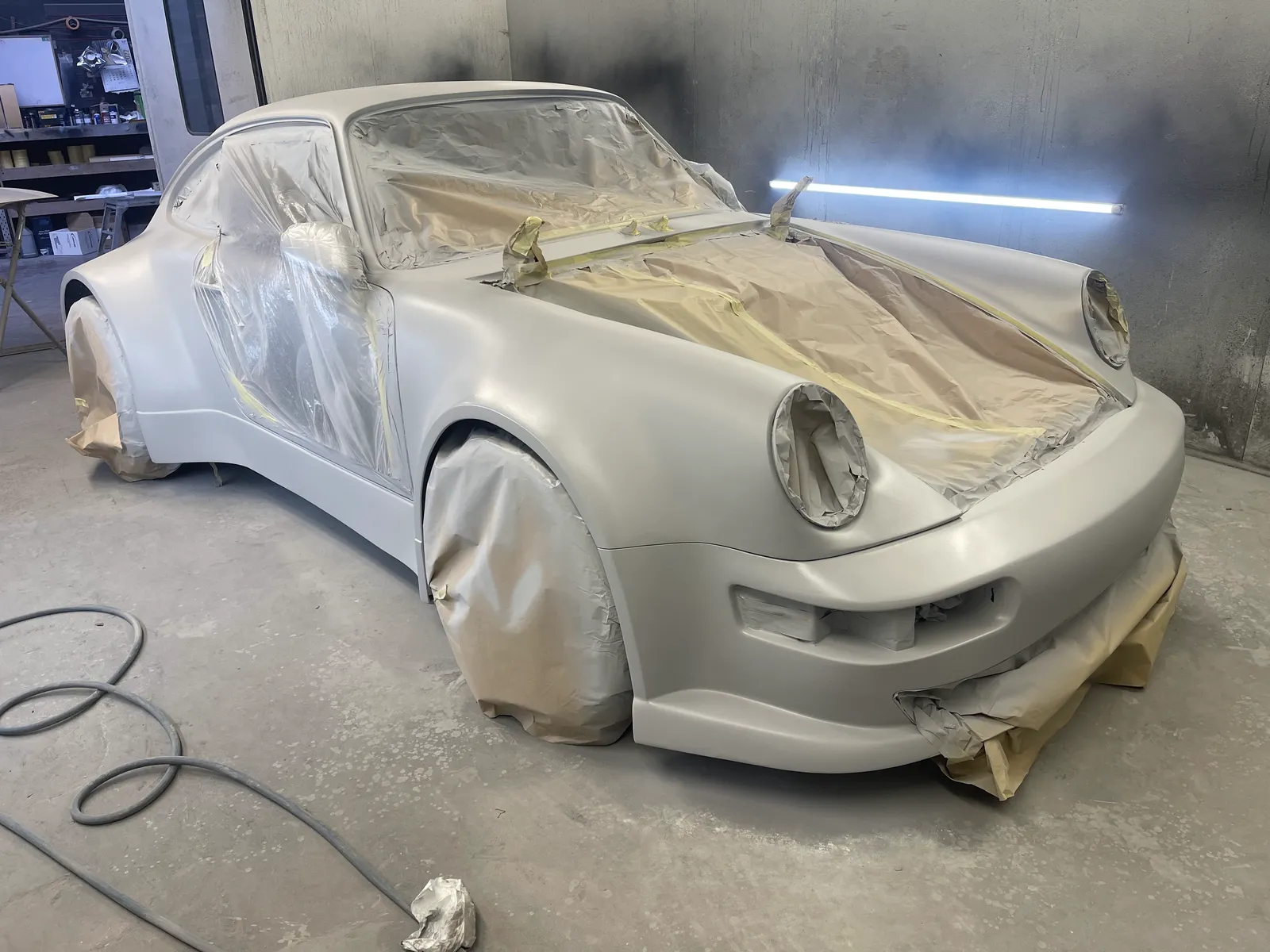 The Porsche 911 masked up inside the spray booth ready for paint