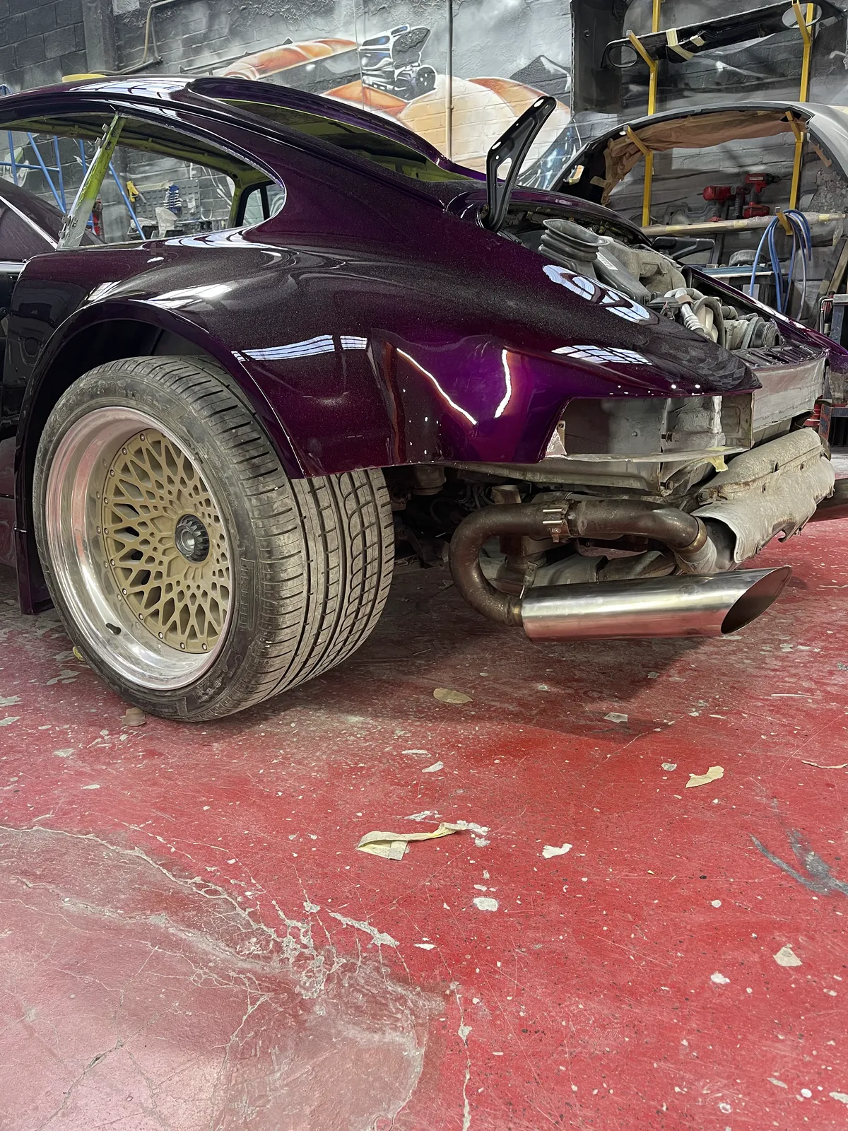 The Porsche 911 in deep aubergine metallic with exhaust fitted